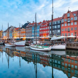 Nyhavn with colorful facades of old houses and old ships in the Old Town of Copenhagen, capital of Denmark.